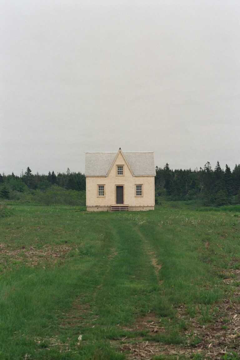 brown concrete house on green grass field